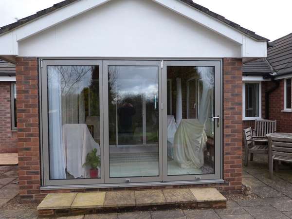 Aluminium bifold doors in a specialised RAL colour. Installed in Manchester.
