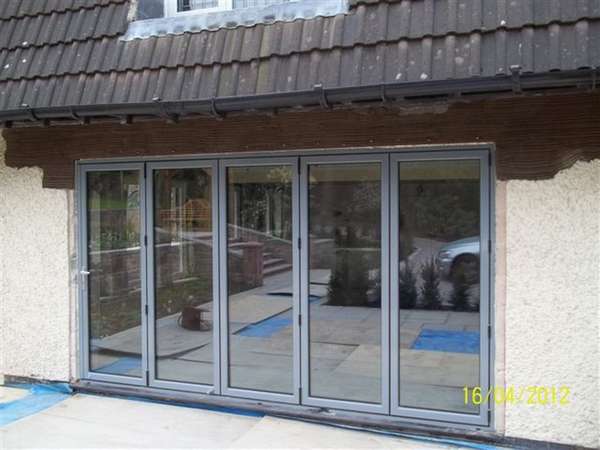 Mrs L: Caldy, Wirral: Installation of steel work and removal of brickwork to form opening. Classic S1 Bi Fold doors. Marine Finish Polyester Coated RAL colour 7031.