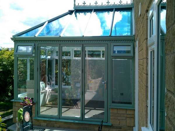 Blackpool : Design and build PvcU Conservatory showing K2 Sage foil roof glazed with Hytherm Self Clean Double glazed units. Matching Sage Green foil PvcU window and Classic S1 Bi fold doors double glazed with Hytherm self cleaning double glazed units.