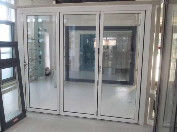 NEW PVCU - AlUMINIUM HYBRID Bi Folding door - Showroom photo. 135mm sight line. Flush floor - 28mm sealed units - 4 foil finishes. Grey . black. Chartwell Green- Cream. Can also be sprayed to any RAL